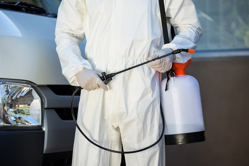 pest control technician in protective suit